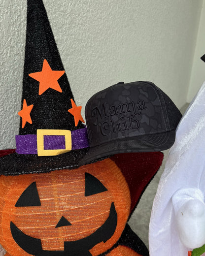 Mama Club black camo trucker on a jack-o-lantern witch hat