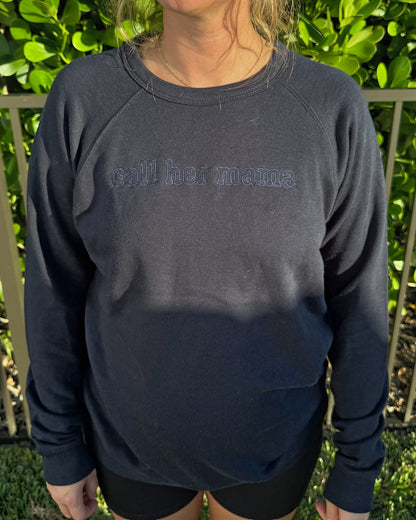 Close-up of the tone-on-tone outline call her mama embroidery on the navy crewneck