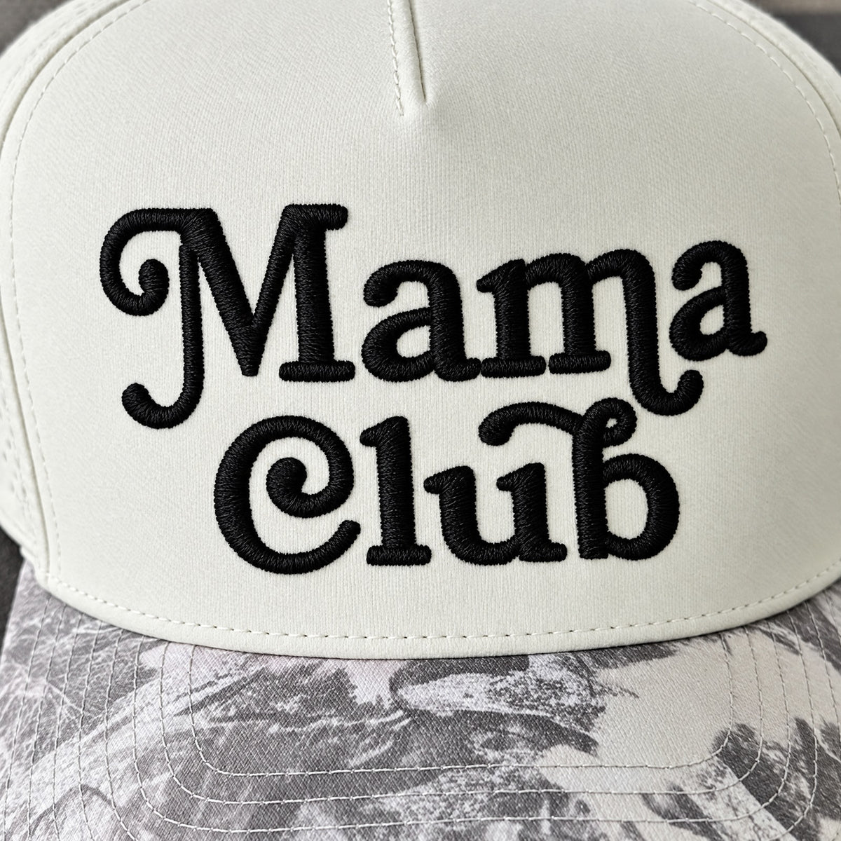 Close-up of the black 3D puff Mama Club embroidery