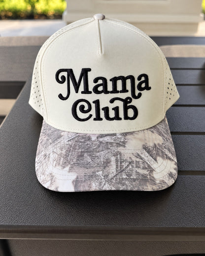 Mama Club white and grey camo trucker on a patio table