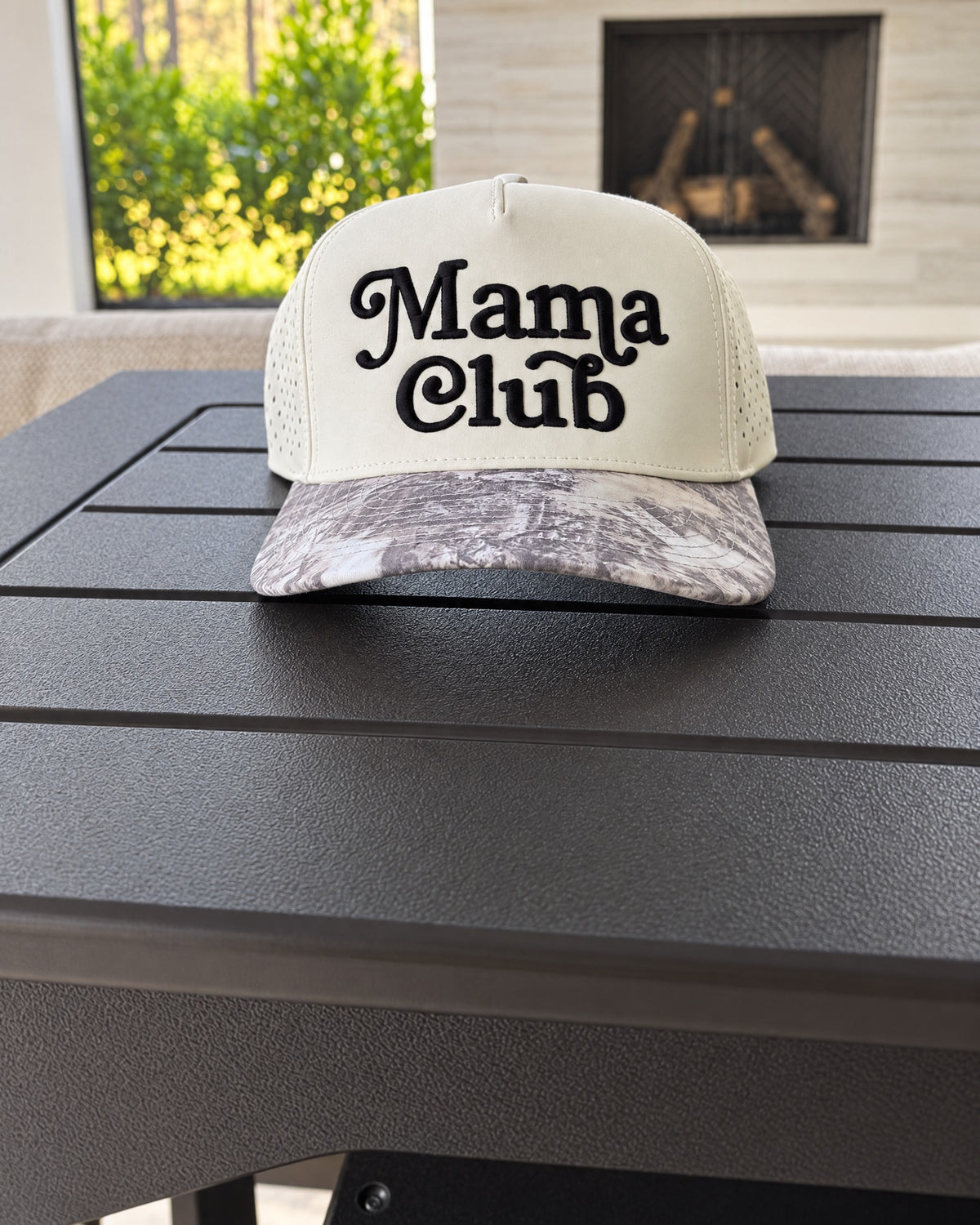 Mama Club white and grey camo trucker on the patio