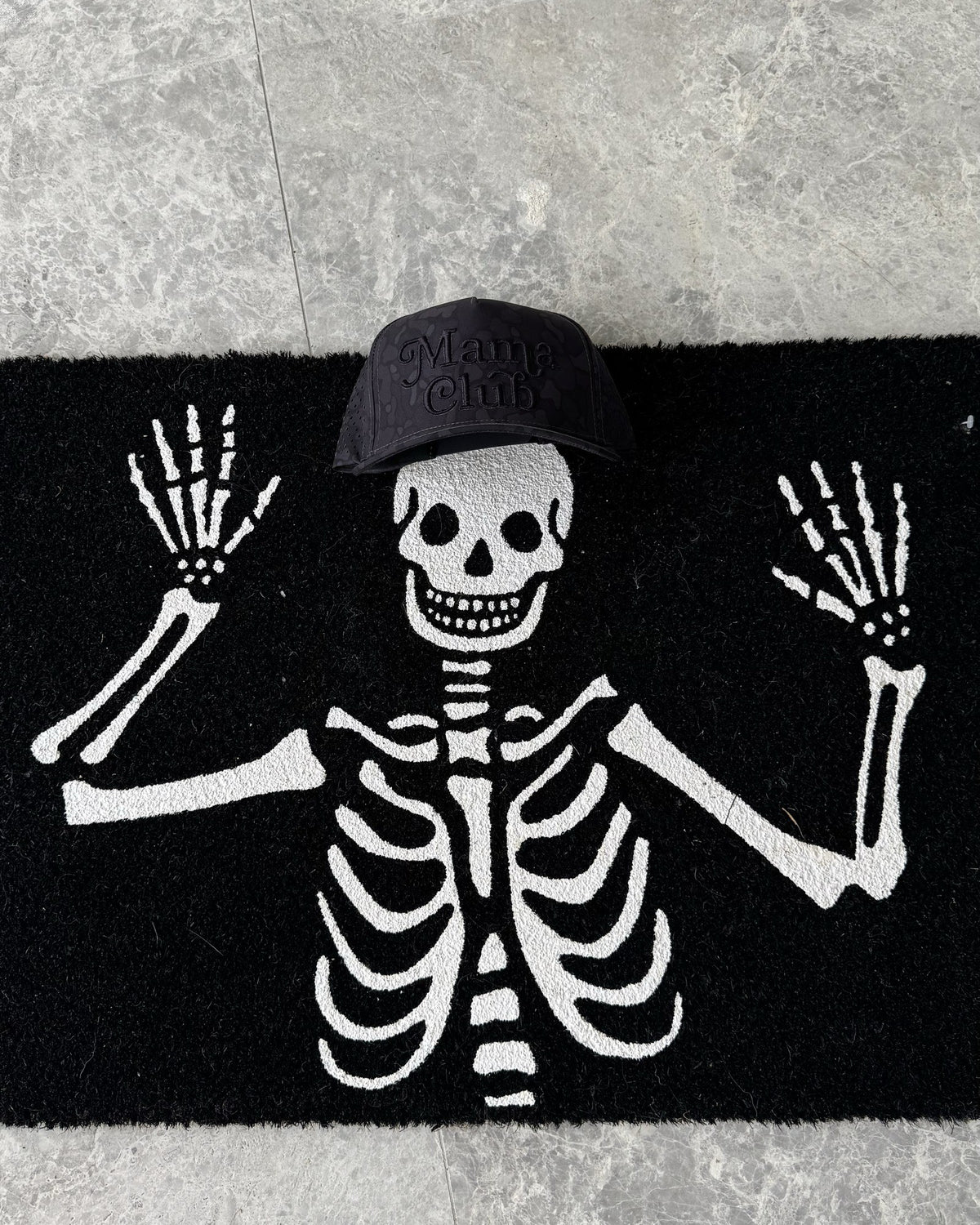 Mama Club black camo trucker on a skeleton Halloween doormat