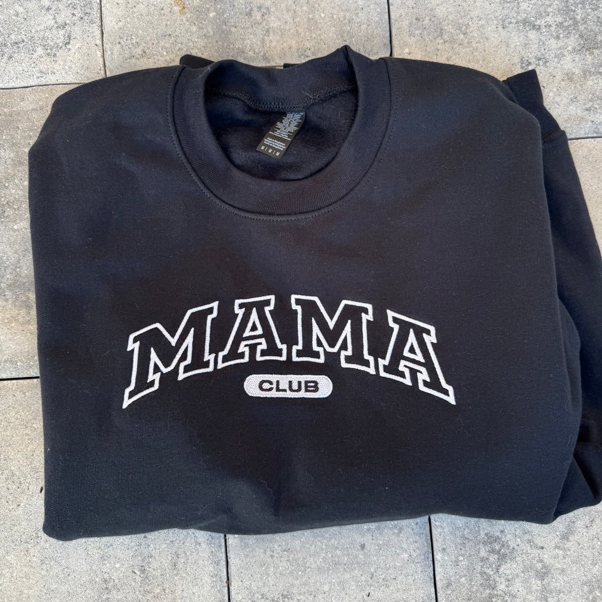 Black Mama Club embroidered crewneck, photographed flat on stone from the Call Her Mama photoshoot