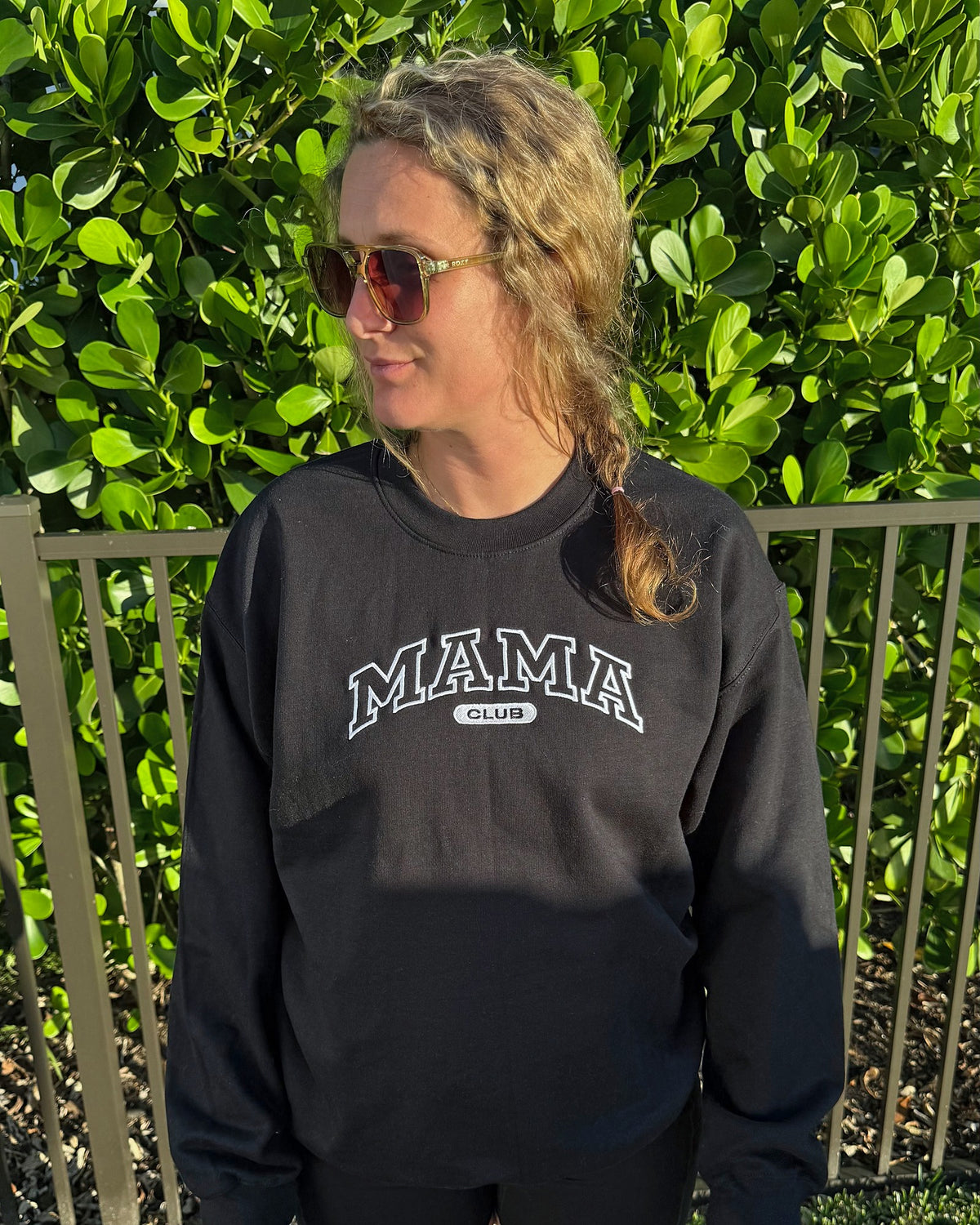 Mama Club embroidered crewneck in black with white MAMA CLUB embroidery, worn outdoors