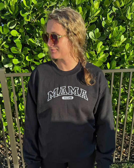 Mama Club embroidered crewneck in black with white MAMA CLUB embroidery, worn outdoors