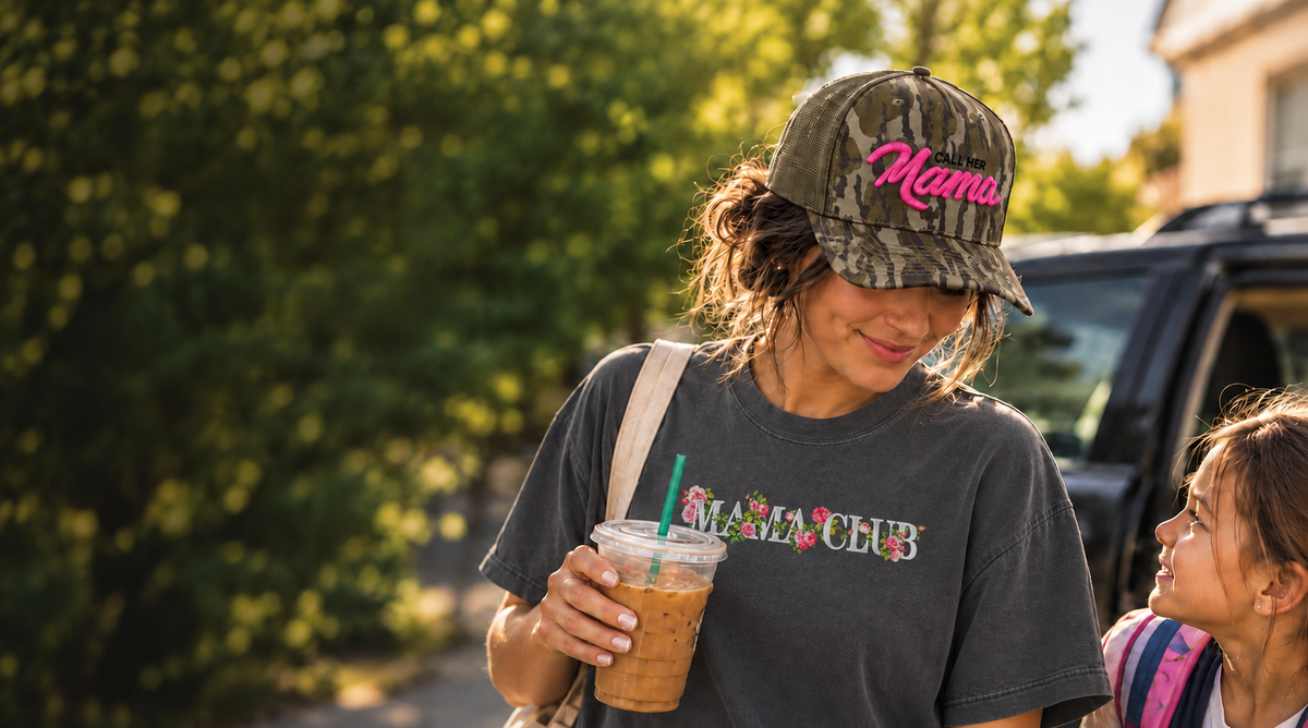 Mother wearing the Call Her Mama Bottomland Camo and Hot Pink hat beside her child
